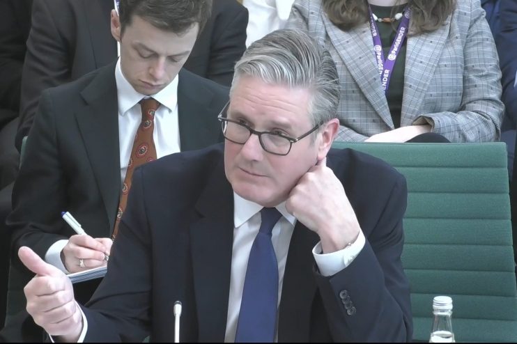 Keir Starmer addressing the Liaison Committee in a formal setting, discussing key political issues and policy matters.