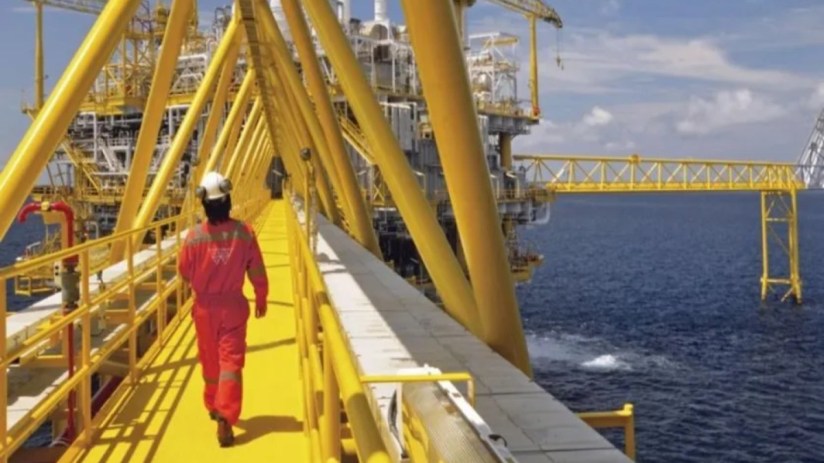 Wood Group engineers collaborating on a project plan in a modern office setting, highlighting teamwork and innovation.