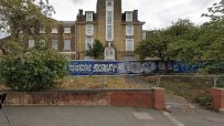 Thorpe Coombe Hospital exterior view from street, showcasing hospital architecture and entrance in urban setting.