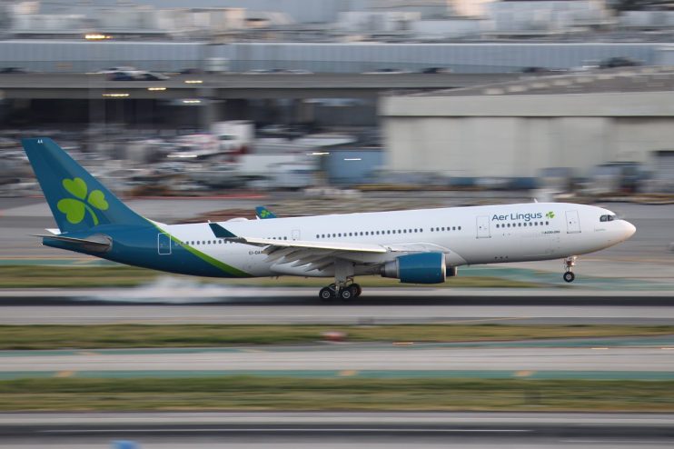 Aer Lingus aircraft on runway at sunrise, highlighting airlines operations and fleet in vibrant morning hues.