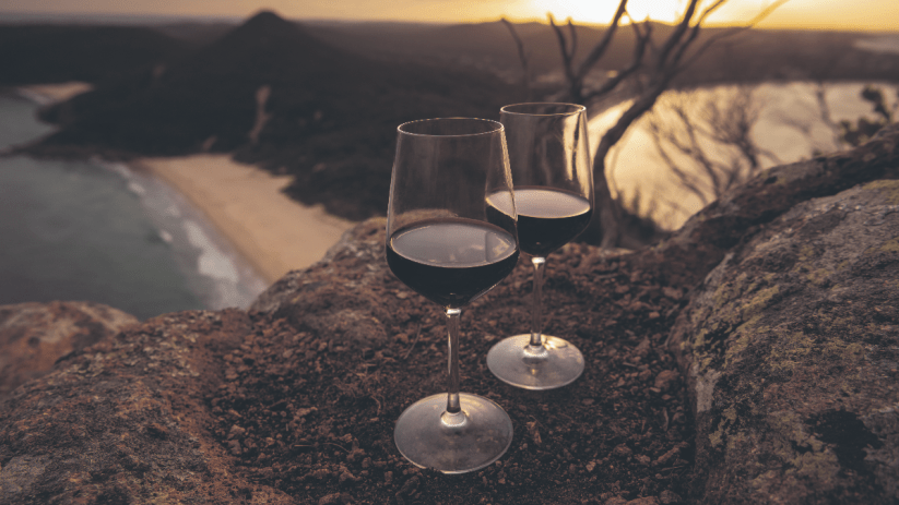 Award-winning Australian wine bottle with vineyard backdrop, showcasing premium wine selection in a business news context