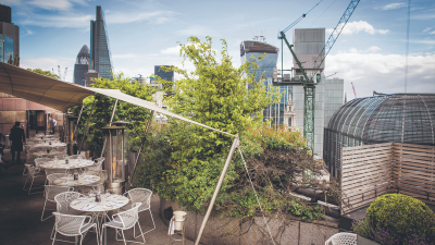 Stunning view of Londons Square Mile from a trendy rooftop bar, highlighting vibrant city skyline and chic outdoor seating