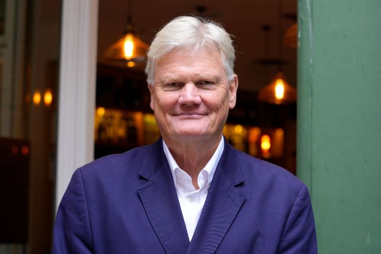 David Page presenting at a business conference with a focus on economic strategies and market trends.