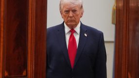 Donald Trump speaking at April event, wearing a suit and tie, with an expressive gesture and a serious facial expression