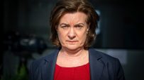 First Minister of Wales Eluned Morgan standing at a podium during a press conference, addressing current Welsh policies