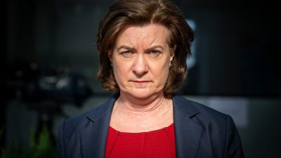 First Minister of Wales Eluned Morgan standing at a podium during a press conference, addressing current Welsh policies