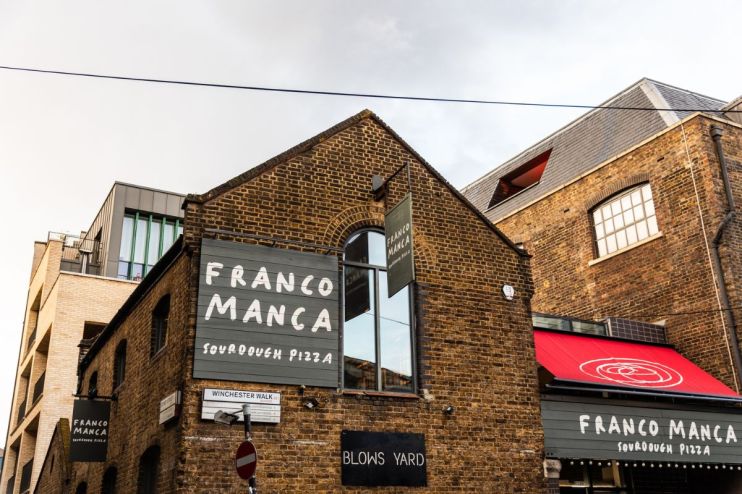Franco Manca restaurant exterior showcasing the vibrant storefront and bustling street atmosphere in a busy city location.