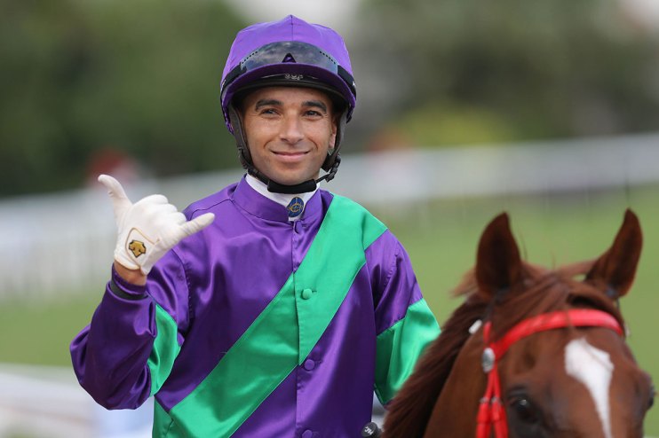 Joao Moreira in action at a prestigious event, showcasing determination and skill in a competitive atmosphere.