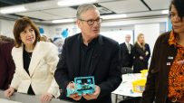 Keir Starmer visiting a local school, engaging with students and staff in a classroom setting, emphasizing education prior...