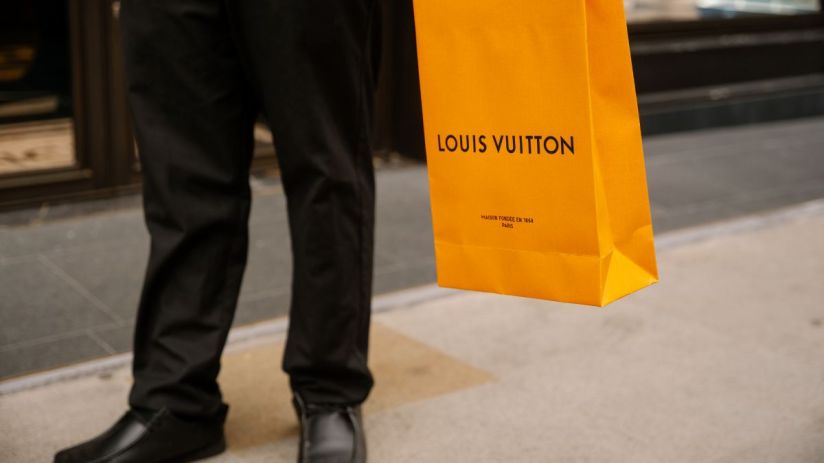 Louis Vuitton luxury handbag display in a high-end retail store showcasing elegant designer fashion accessories.