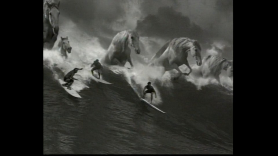 Guinness Surfer 1999 iconic advertisement featuring surfers riding powerful waves with a dramatic ocean backdrop