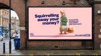 Savvy the squirrel wearing a campaign hat, surrounded by signs, highlighting its role in the latest community initiative
