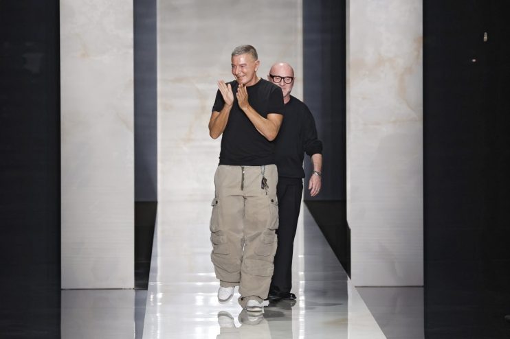 Stefano Gabban appearing at a business event, dressed in a formal suit, engaging with attendees in a professional setting.
