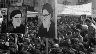 Tehran embassy siege showing armed forces surrounding the building with crowds gathered outside in tense standoff