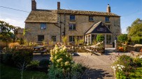 The Killingworth Castle in Cotswolds showcasing its historic architecture amidst scenic countryside surroundings