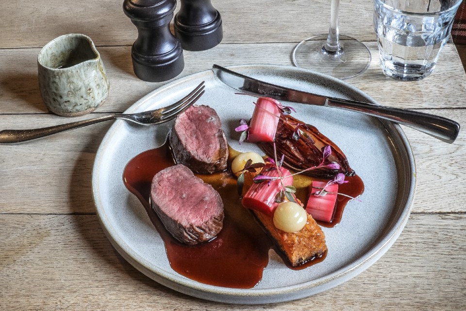 Gourmet dish at The Killingworth Castle showcasing vibrant fresh ingredients and culinary artistry in a rustic pub setting.