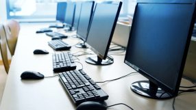 Modern computer workstation with sleek design, featuring dual monitors, ergonomic keyboard, and contemporary office decor.