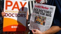Doctors rallying with placards during a strike, advocating for better working conditions and fair wages in healthcare.