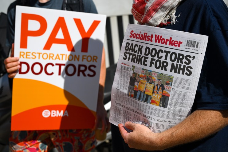 Doctors rallying with placards during a strike, advocating for better working conditions and fair wages in healthcare.