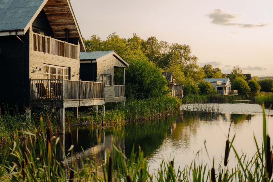 Breaking news event with a crowd gathered at a press conference, microphones set up on a podium, and journalists taking notes