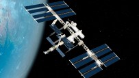 International Space Station orbiting Earth with solar panels extended against a backdrop of stars and the blue planet below