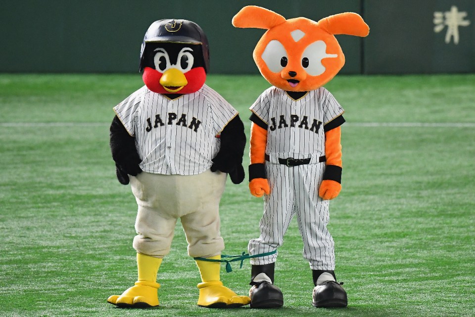 Colorful mascots entertaining a crowd at a business event, showcasing lively characters in a vibrant setting