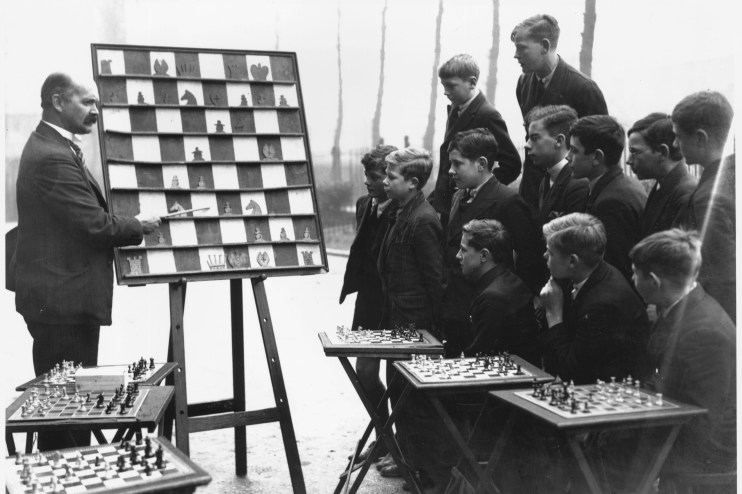 Young mentor guiding diverse group of teenagers in a collaborative workshop setting, emphasizing education and personal gr...