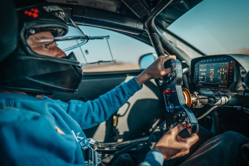 McLaren sports car on track at PalmerSport driving event, showcasing sleek design and high-performance capabilities
