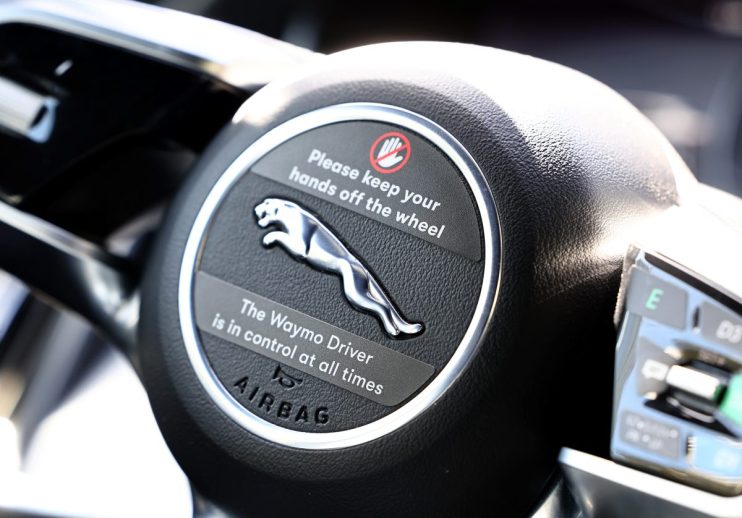 Waymo Jaguar driverless taxi showcasing autonomous technology in urban environment for innovative transportation solutions