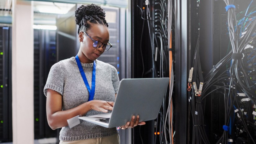 IT professional managing server room equipment with focus on advanced technology and network infrastructure