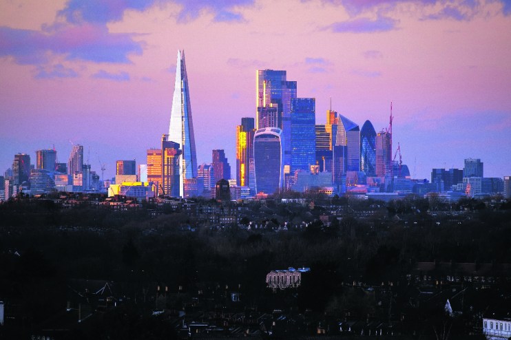 City of London skyline featuring iconic skyscrapers and modern architecture against a clear blue sky