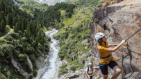 Breathtaking view of the Austrian Alps, featuring snow-capped peaks and lush greenery, ideal for adventure holidays.