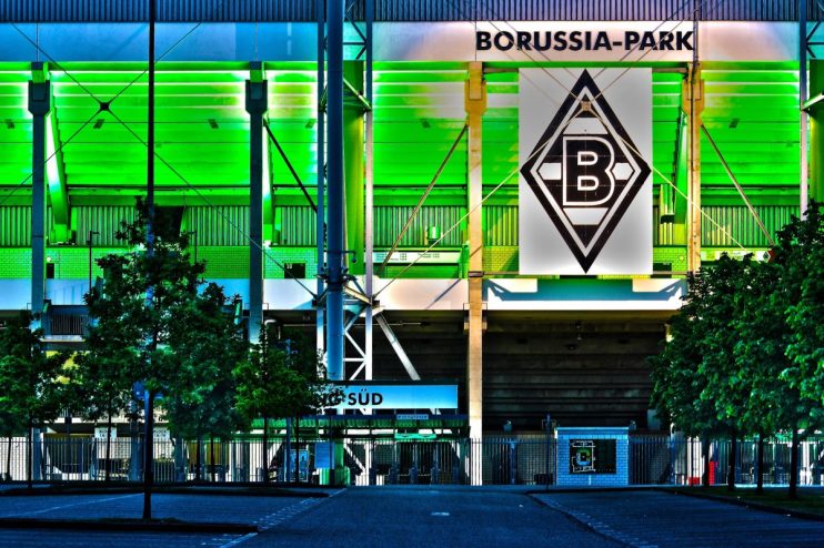 Borussia Park stadium exterior under cloudy sky, home to Bundesligas Borussia Mönchengladbach, showcasing modern architec...
