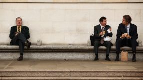 Businessman eating lunch outdoors in City of London financial district
