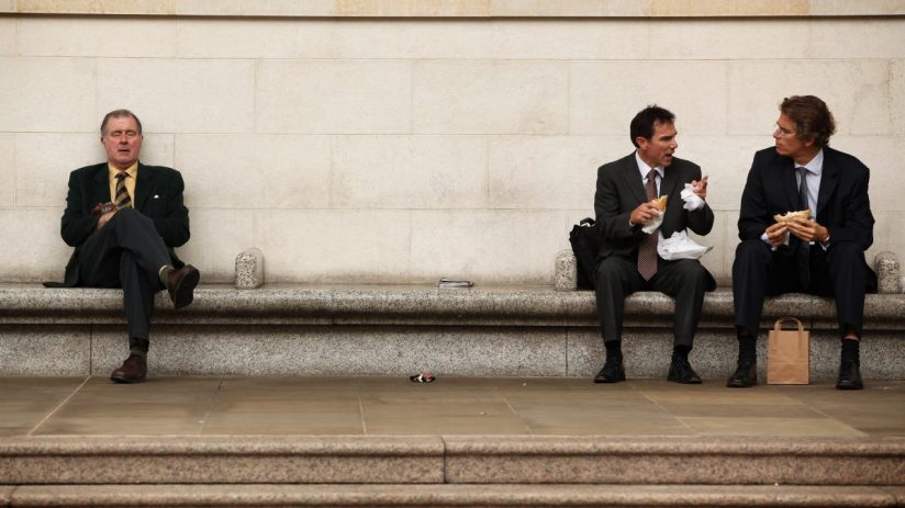Businessman eating lunch outdoors in City of London financial district
