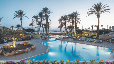 Scenic view of Cyprus coastline with sunny weather, traditional food, and refreshing drinks for travelers