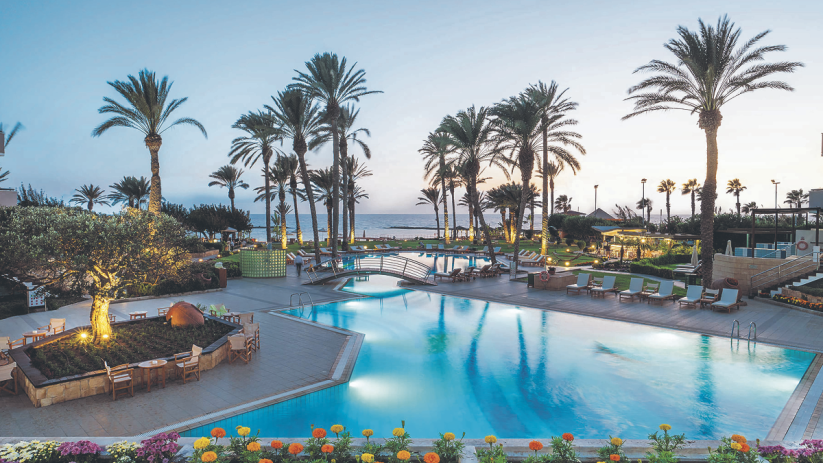 Scenic view of Cyprus coastline with sunny weather, traditional food, and refreshing drinks for travelers