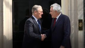 Gordon Brown and Keir Starmer engaged in discussion at a public event, emphasizing leadership and political strategy.