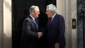 Gordon Brown and Keir Starmer engaged in discussion at a political event, highlighting leadership and policy collaboration