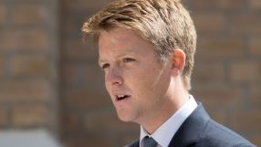 Hugh Grosvenor, dressed in a tailored suit, attending a high-profile business event, engaging with industry leaders.