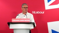 Keir Starmer delivering a speech at a podium, addressing audience with focused expression, highlighting key political points