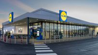 Lidl store entrance with shopping carts and customers entering on a busy day