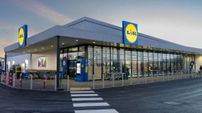 Lidl store entrance with shopping carts and customers entering on a busy day