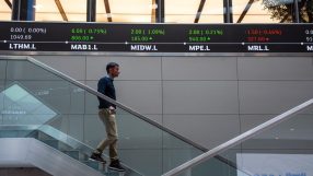 Traders analyzing data on screens at London Stock Exchange, showcasing investment trends and market activity
