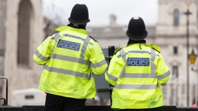 London police officers patrolling the streets, ensuring public safety and security during a busy day in the city.