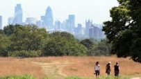 Stunning panoramic view of Londons iconic skyline featuring the Thames River and historical landmarks at sunset