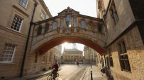 Oxford cityscape featuring historic architecture under clear skies, highlighting iconic landmarks and vibrant autumn foliage