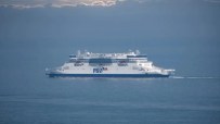 P and O ferry docked at a busy port under clear skies, highlighting maritime operations and transportation activities.