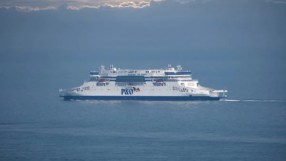 P and O ferry docked at a busy port under clear skies, highlighting maritime operations and transportation activities.