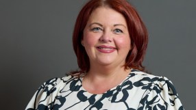 Paula Barker speaking on bond markets aligning with Andy Burnhams economic views, addressing audience at conference.